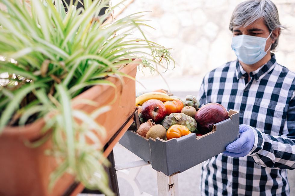 A businessman volunteers at a local food pantry while looking for a job