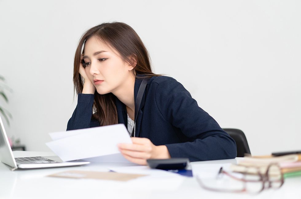 A businesswoman appears to be bored with her job.