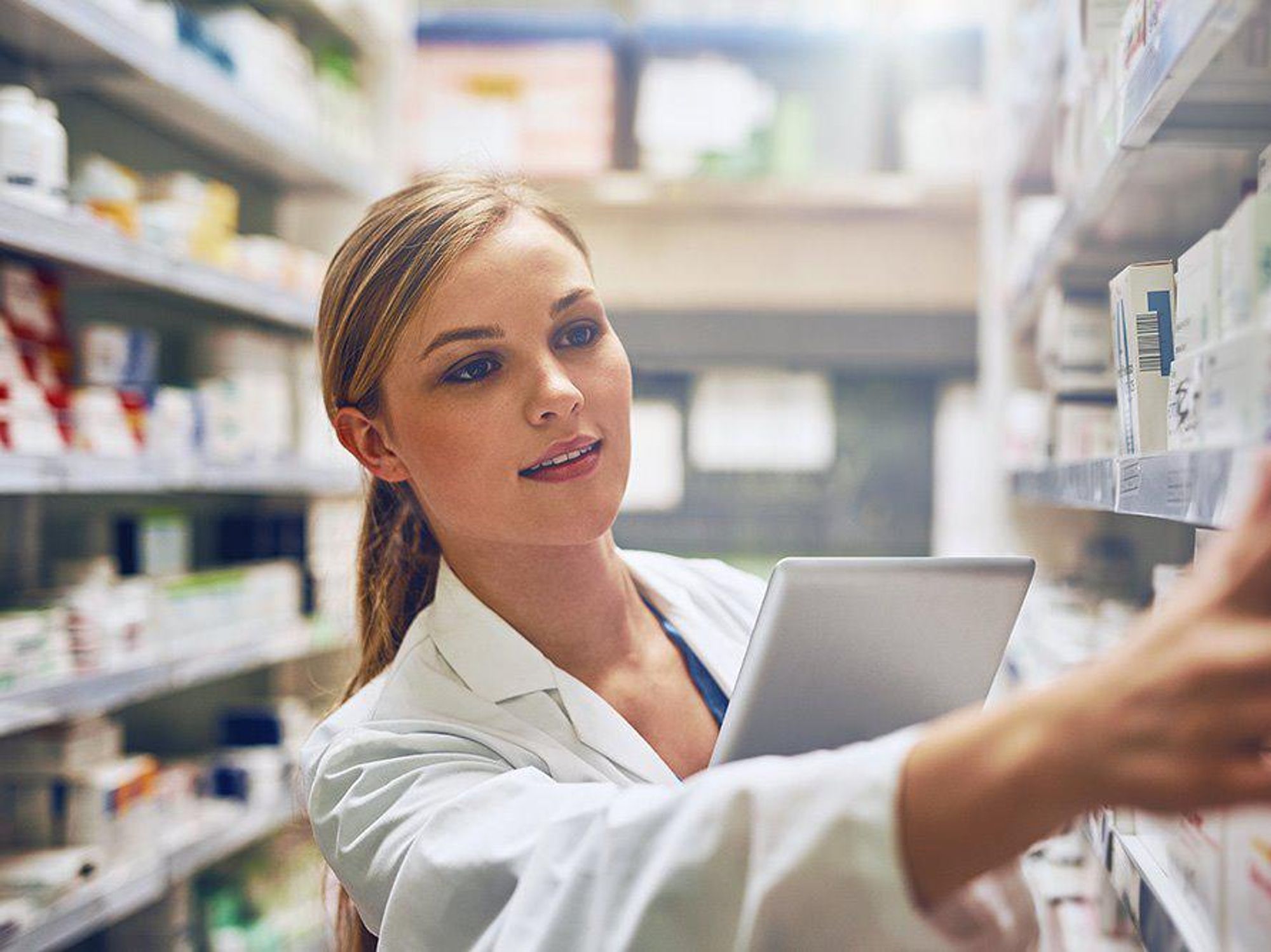 A CVS pharmacy technician works to fill a prescription.