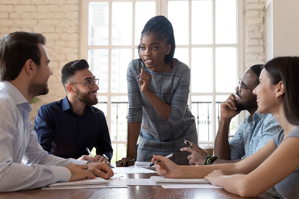 A good leader shares her passion with her employees during a team meeting
