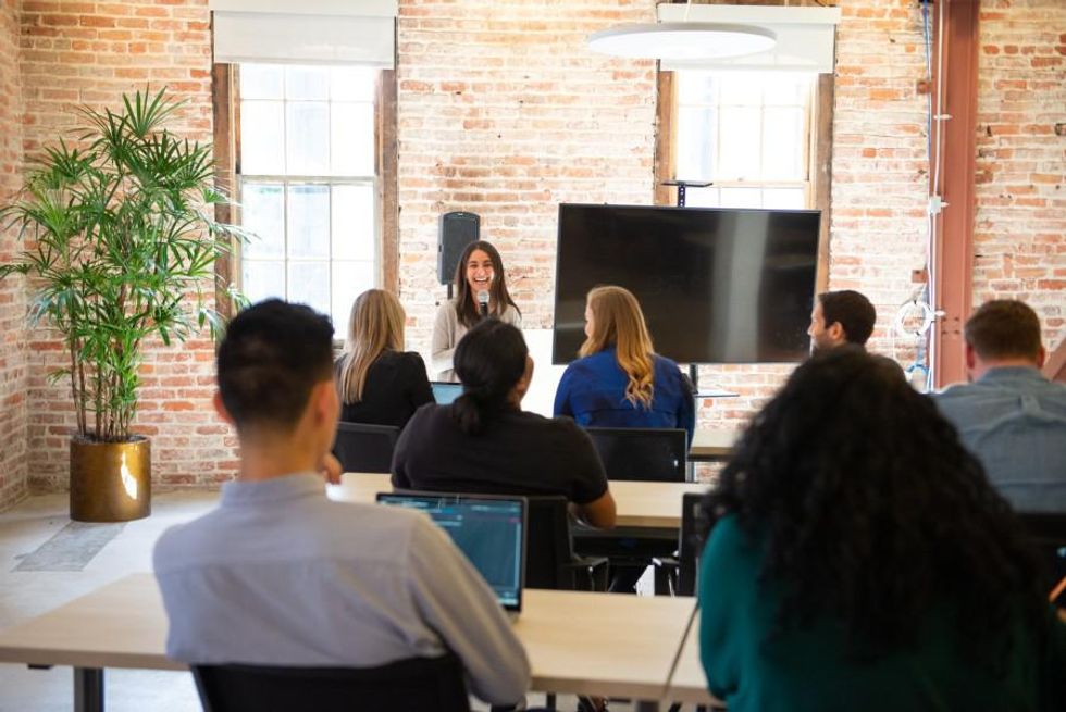 A group of Brex employees hold a group discussion.