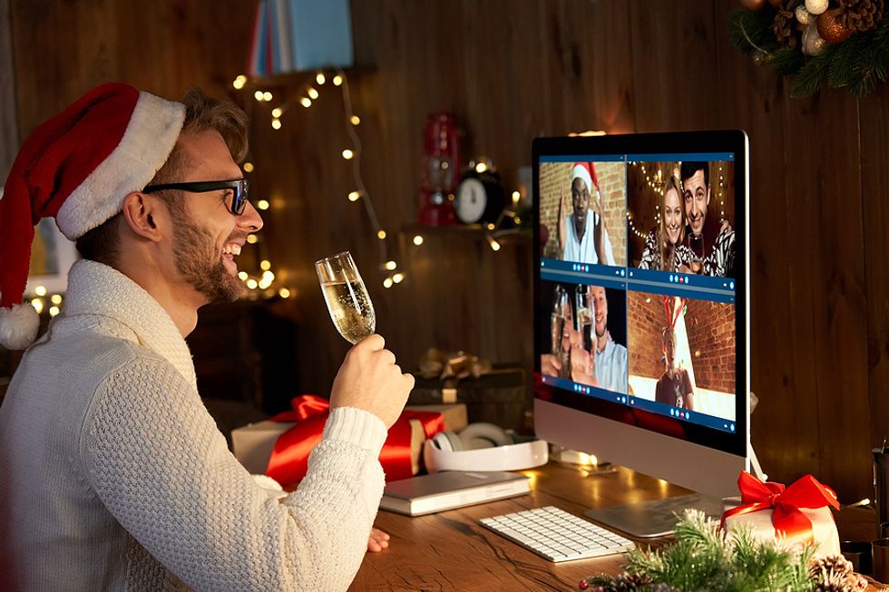 A group of coworkers take part in a virtual holiday party.