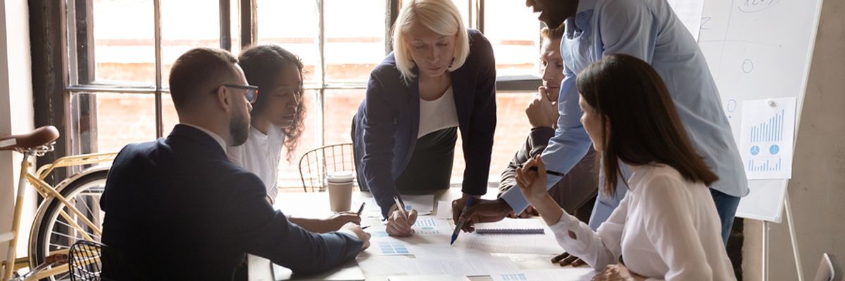 A group of employees works to develop a strategy for the workplace.