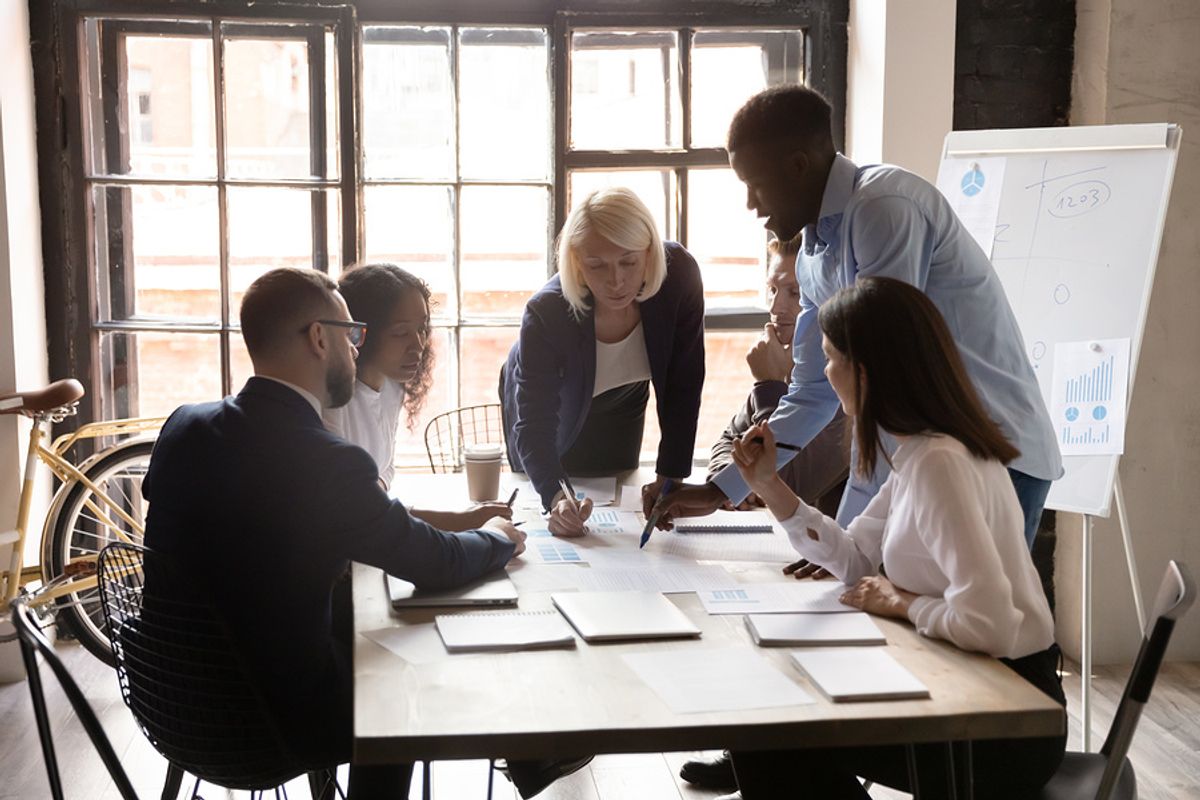A group of employees works to develop a strategy for the workplace.