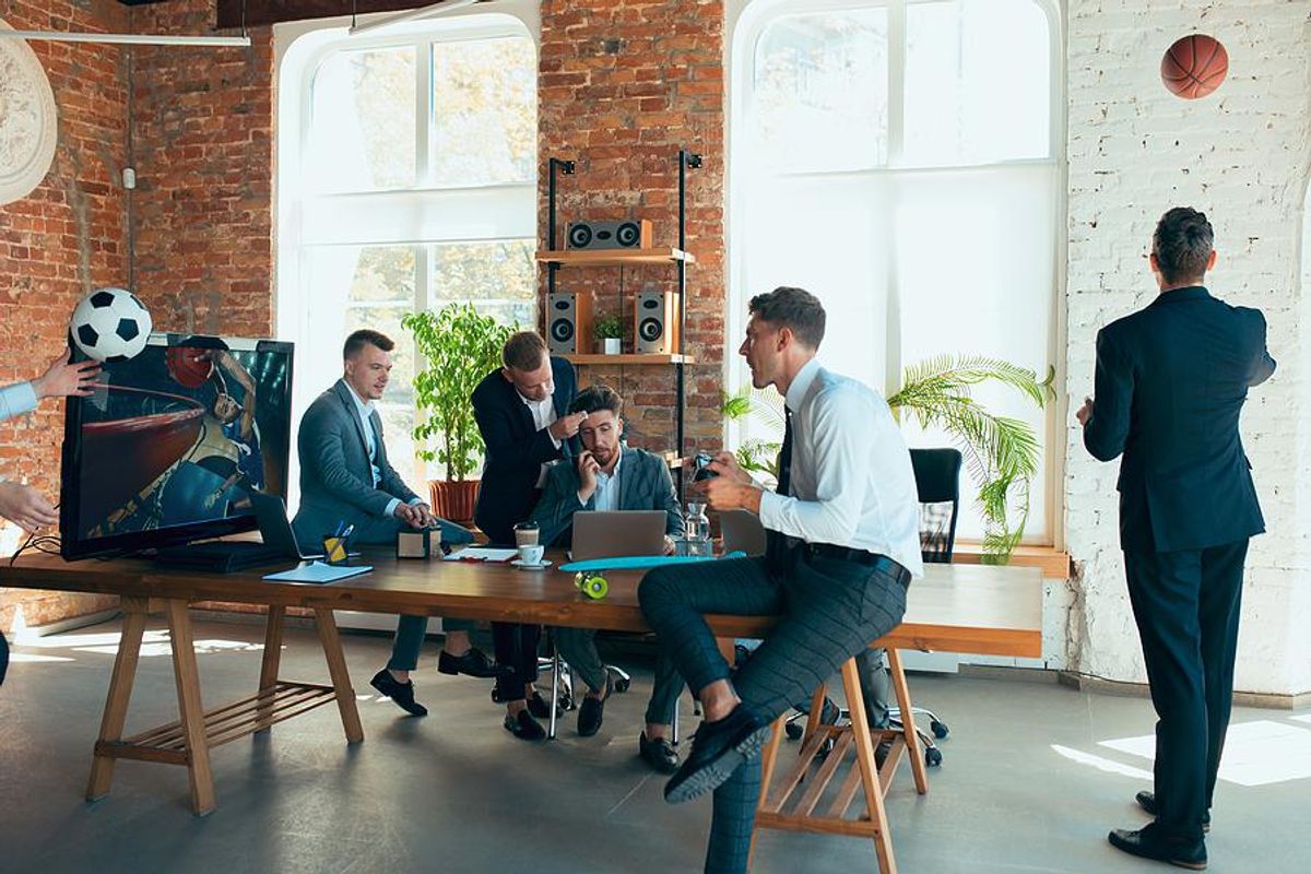 A group of sports fans work together in an office setting.