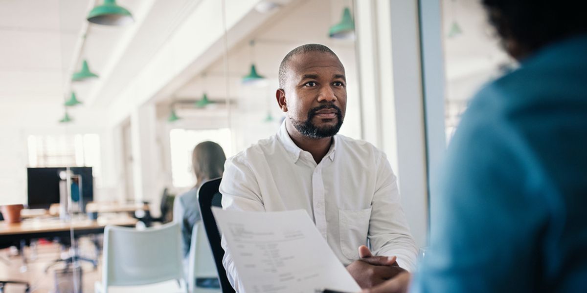 A job candidate considers his strengths and weaknesses during an interview.