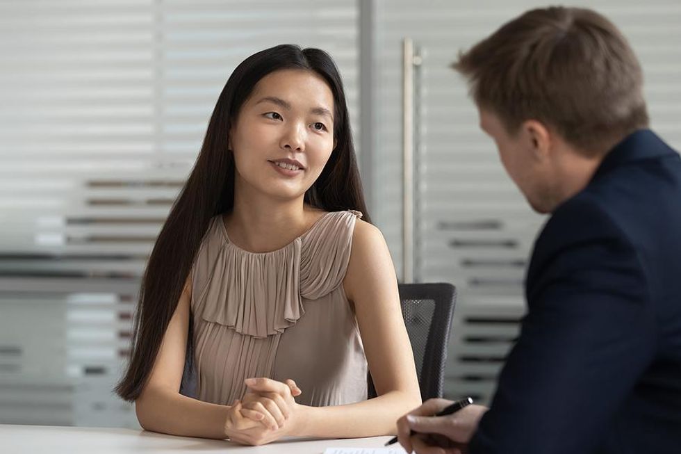 A job seeker confidently answers an interview question.