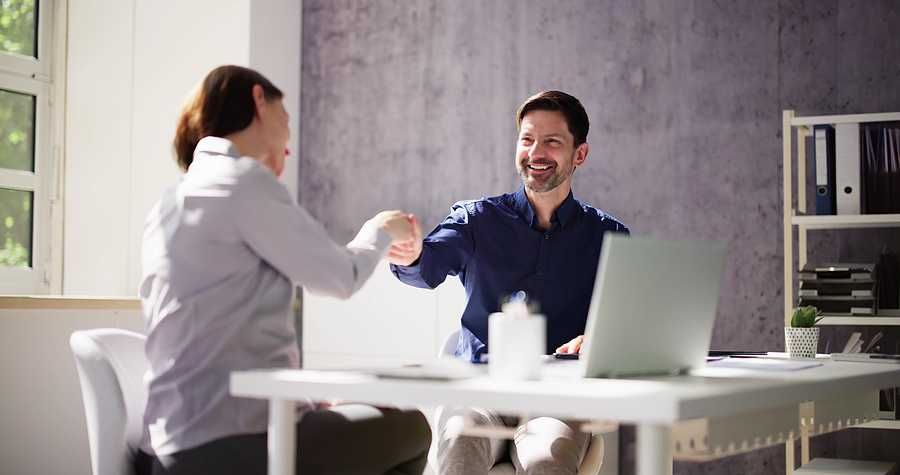 A leader engaging in authentic conversation with a colleague, symbolizing human connection over perfection