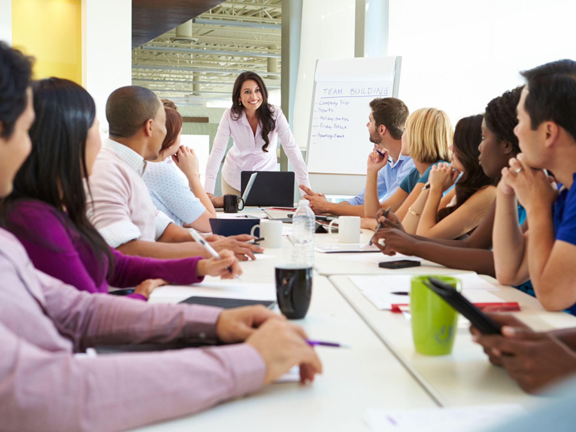 A manager leads a company meeting.