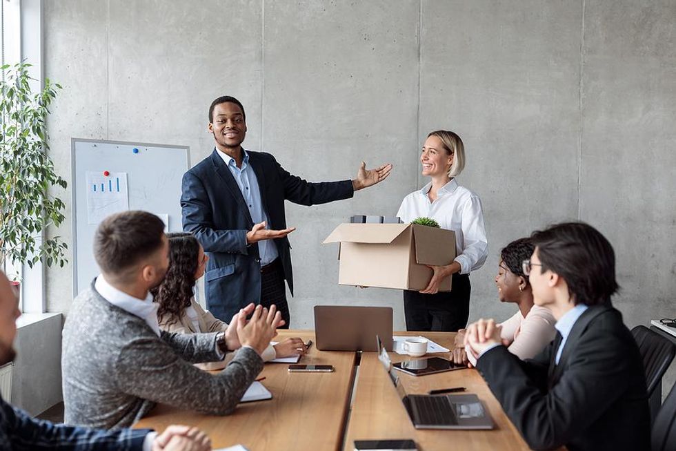 A manager welcomes a new employee to the company on her first day