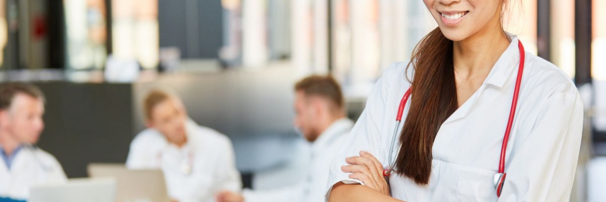 A nurse takes a break after meeting with some colleagues.