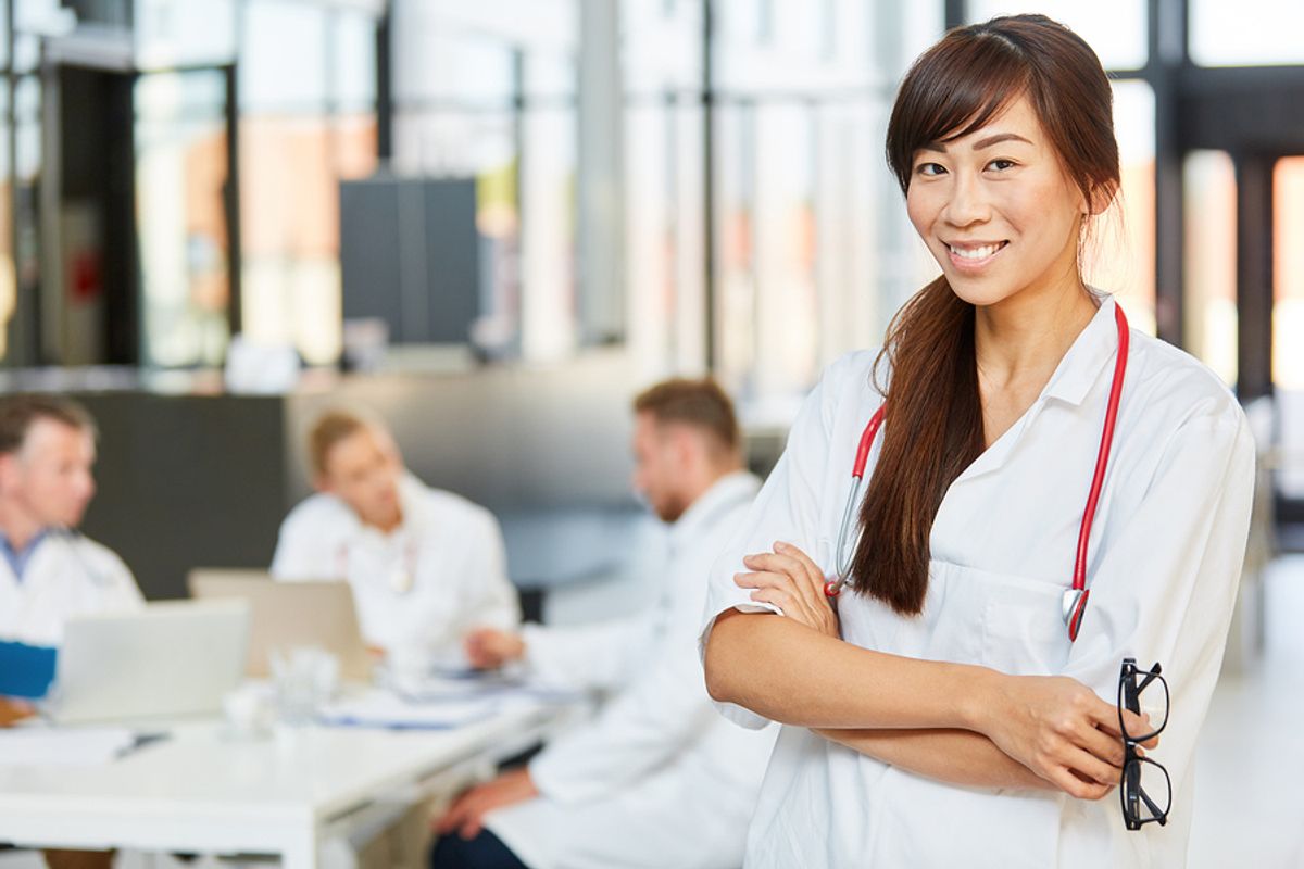 A nurse takes a break after meeting with some colleagues.