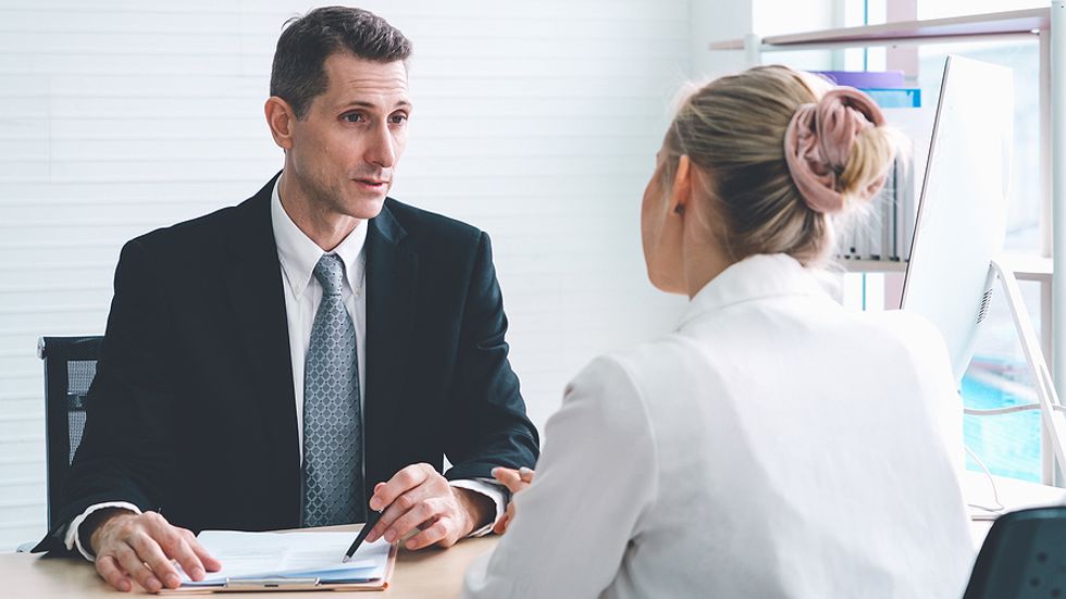 A recruiter goes over the next steps with a job candidate during a job interview