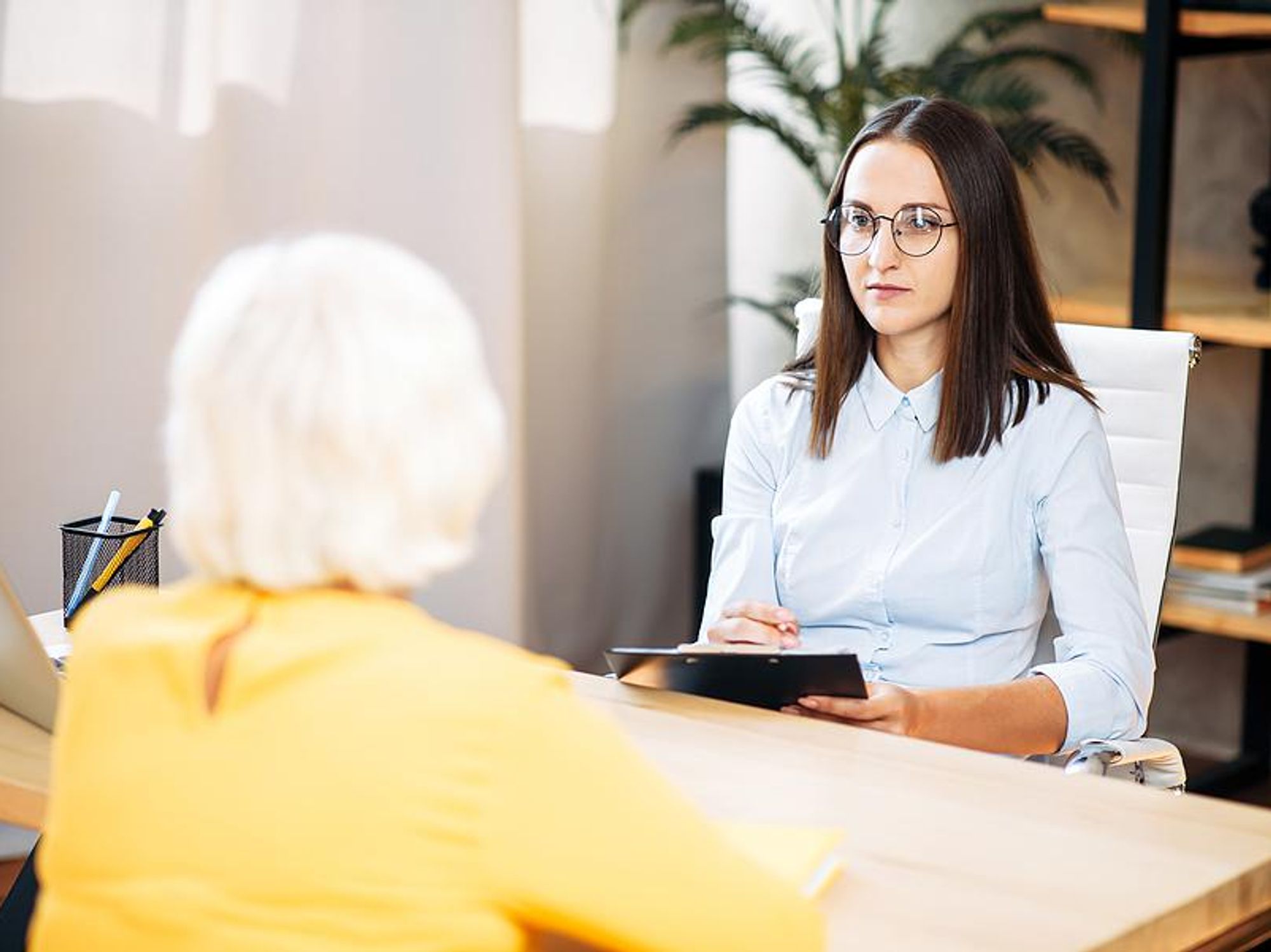 A recruiter listens to a question from a job candidate during an interview.