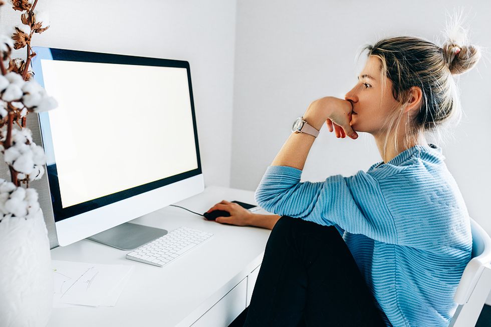 A recruiter on her computer does research on a potential job candidate