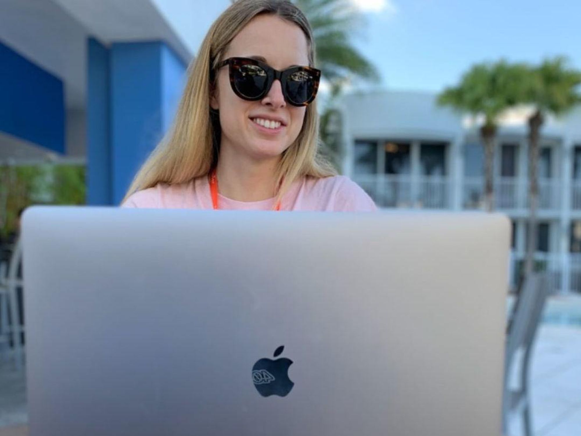 A remote worker at Zapier works poolside. 