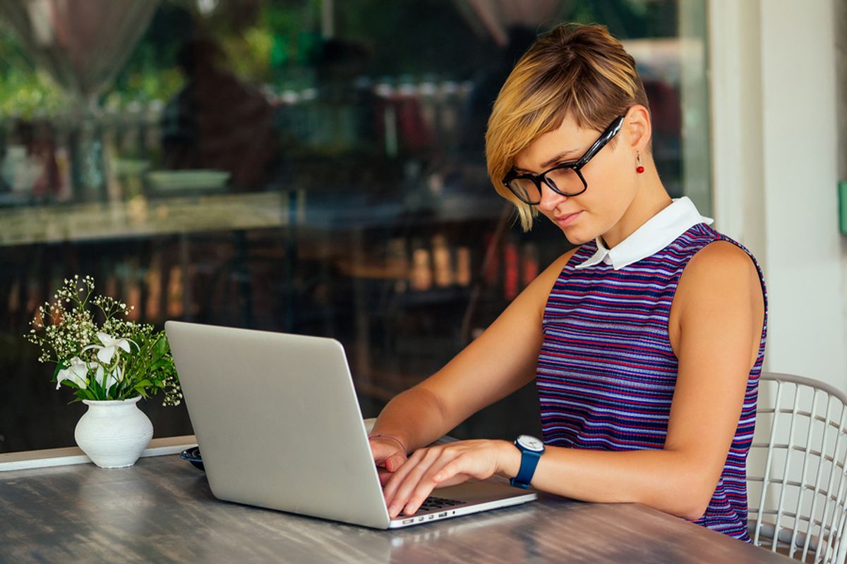 A remote worker completes a project while working outside.