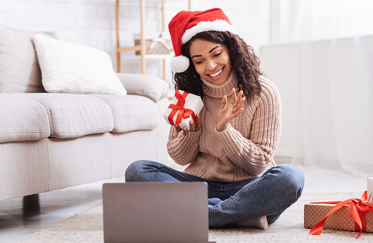 A remote worker takes part in a virtual holiday party.