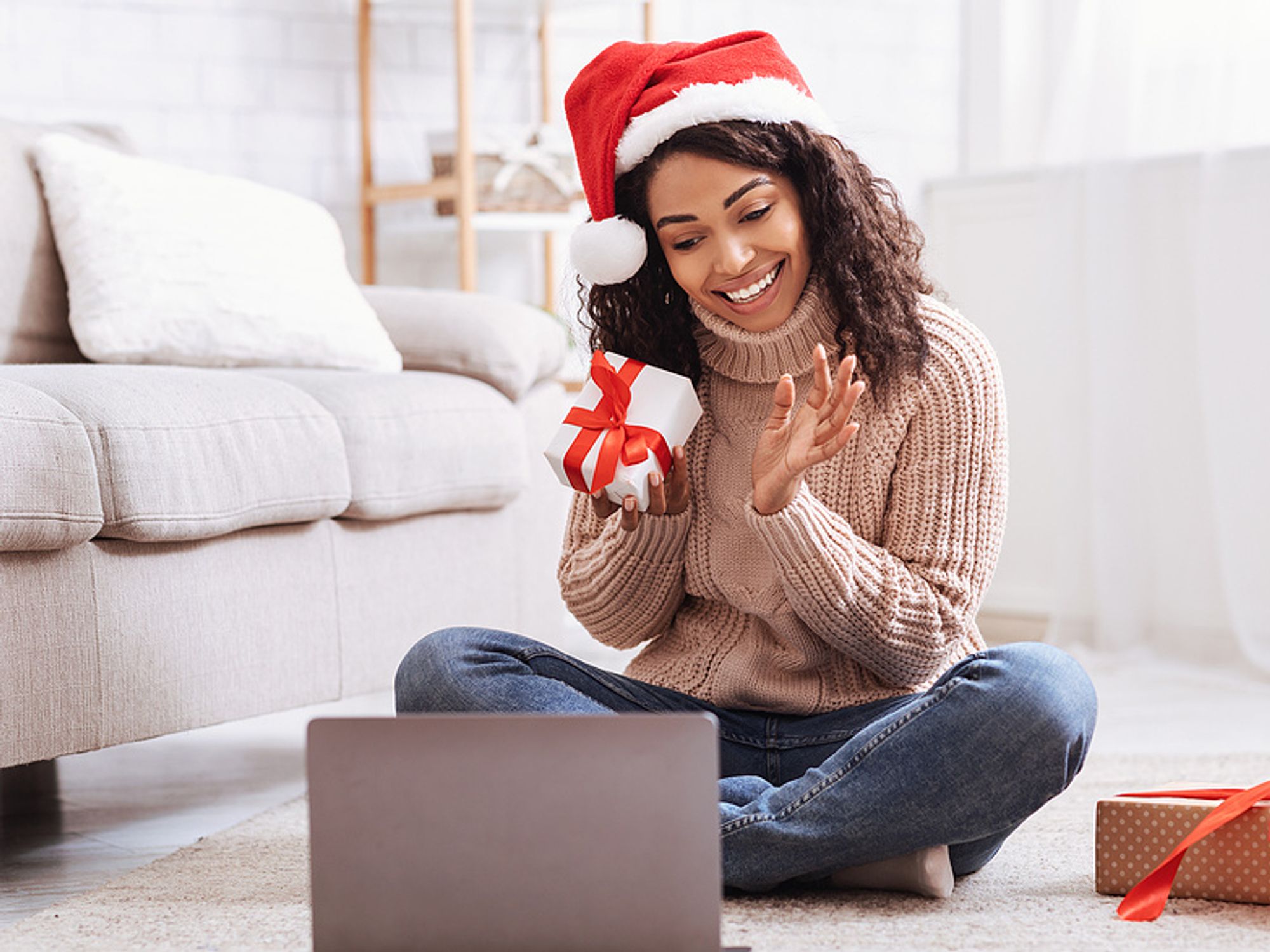 A remote worker takes part in a virtual holiday party.