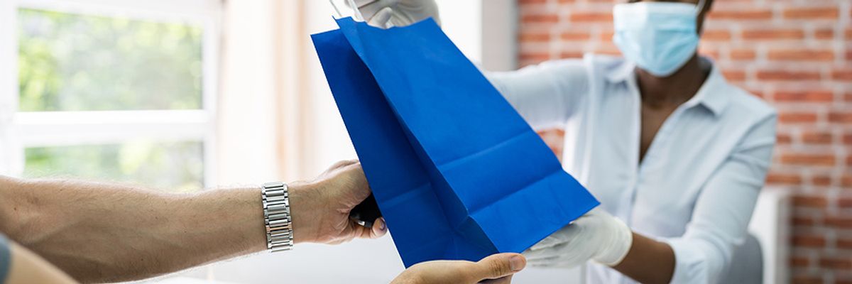 A retail cashier assists a customer with an order.