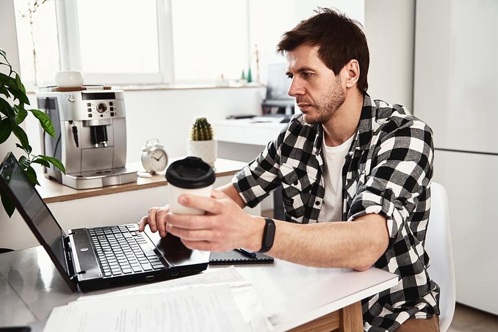 A stressed out remote worker begins his day early.