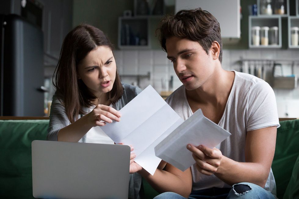 A young couple reviews all of their expenses