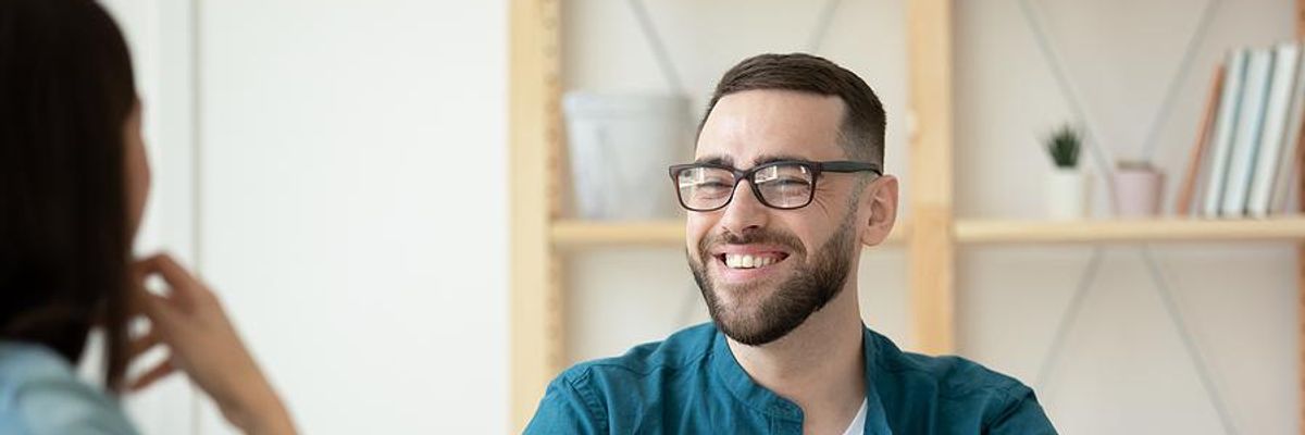 A young job seeker smiles during a job interview.