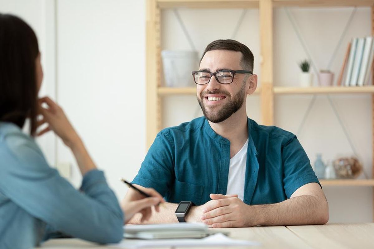 A young job seeker smiles during a job interview.