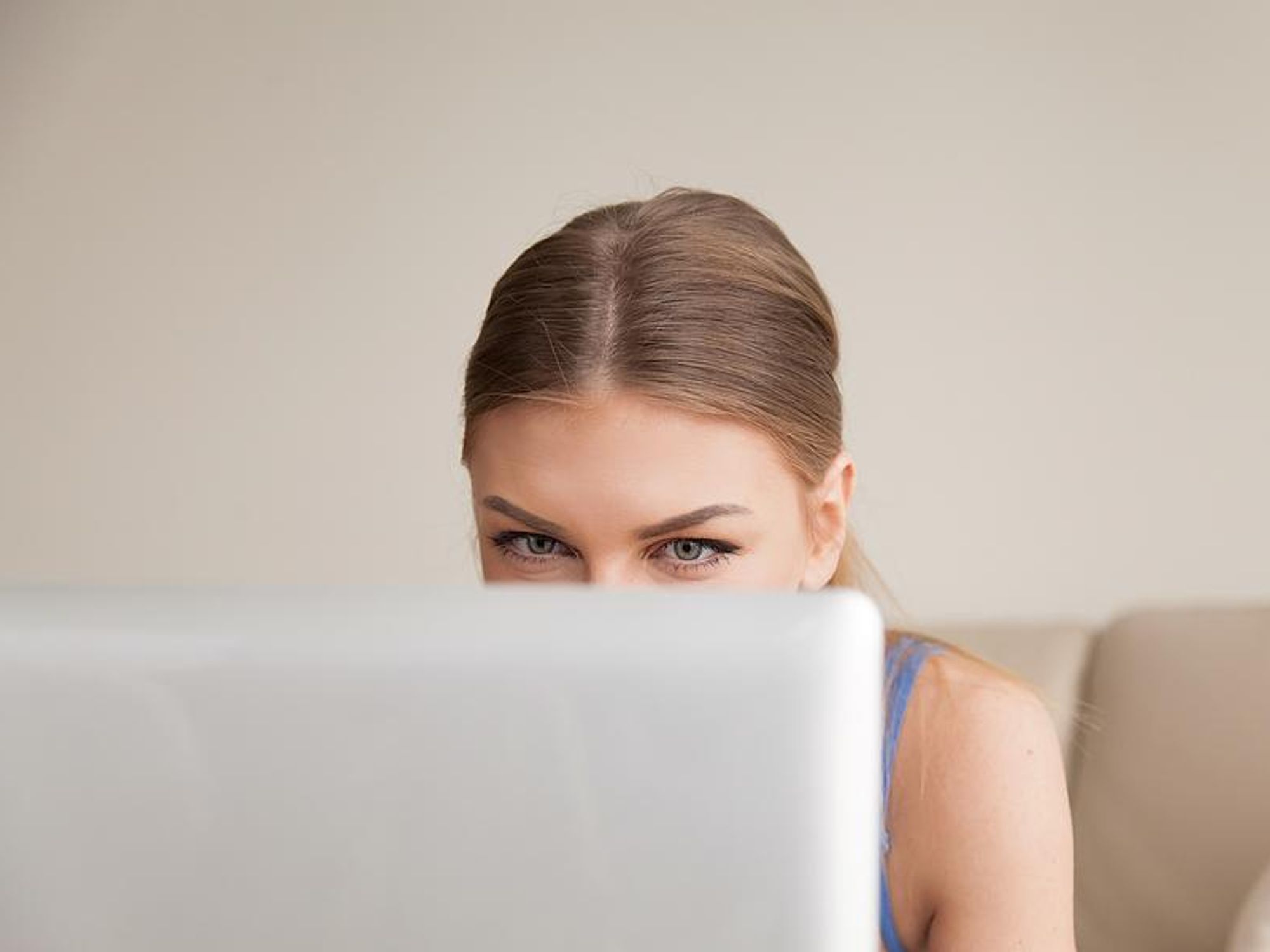 A young professional discreetly updates her LinkedIn profile.