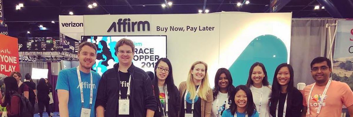 Affirm employees pose for a photo at a conference.