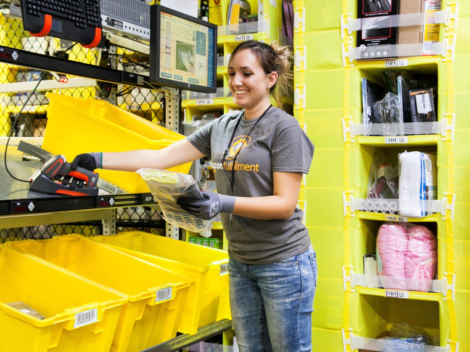 An Amazon warehouse worker fulfills an order.