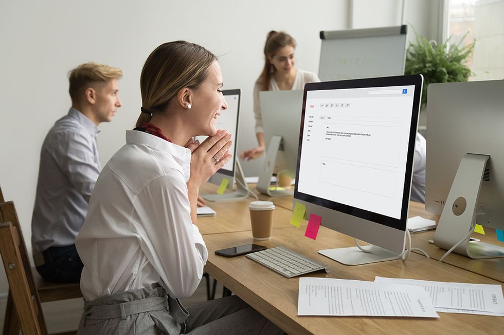 An employee celebrates getting good career news at work