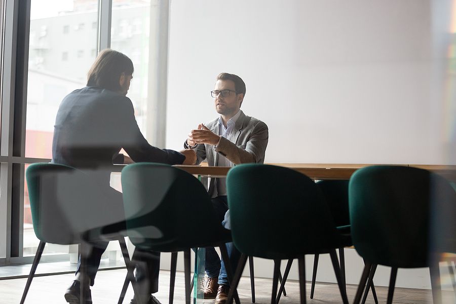 An employee discusses his salary with his supervisor during a meeting