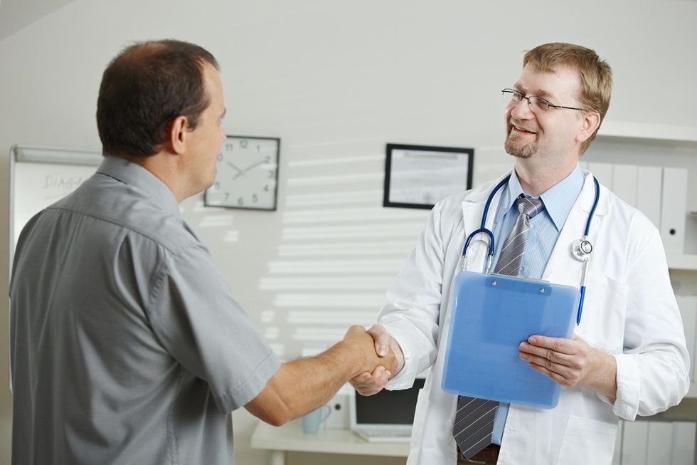 An executive speaks to his doctor during a routine physical.