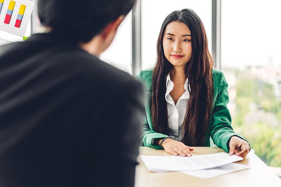 An HR manager listens to a question from a job candidate during an interview