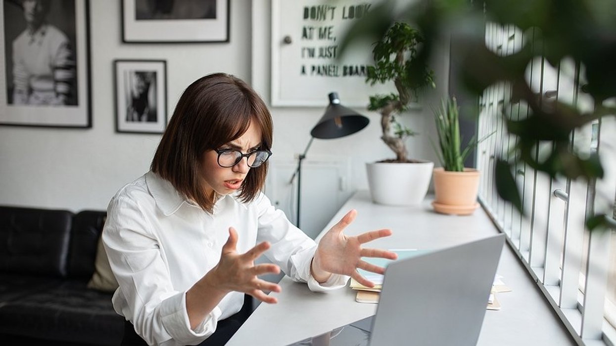 Angry/frustrated woman on laptop wonders why she keeps getting rejecting from jobs she's qualified for