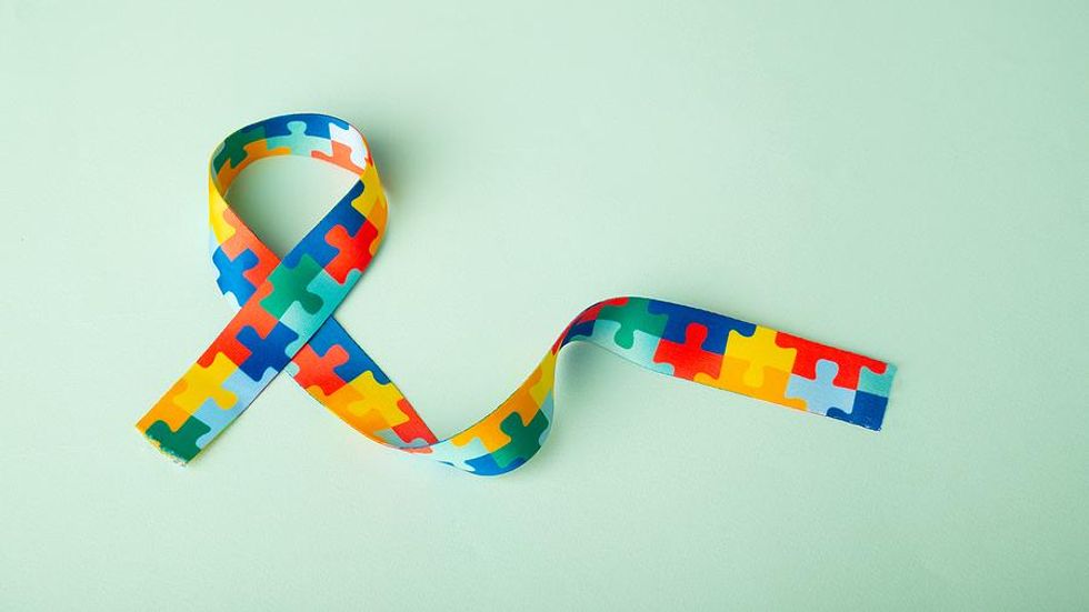 Autism awareness and pride day puzzle ribbon