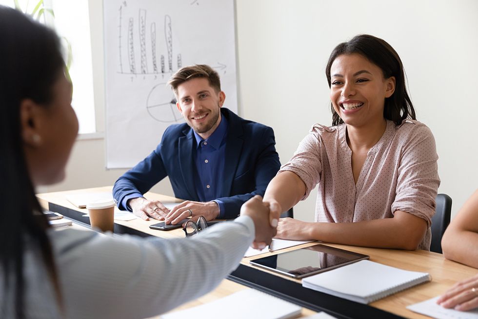 Banking executives talk with a client during COVID-19