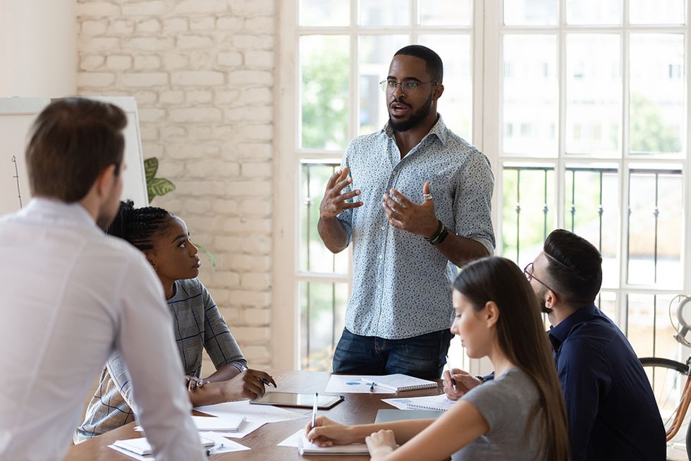 Business leader/ CEO says something during a work meeting