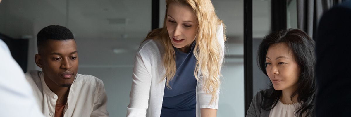 Business leader talks to her co-workers during the COVID-19 pandemic 