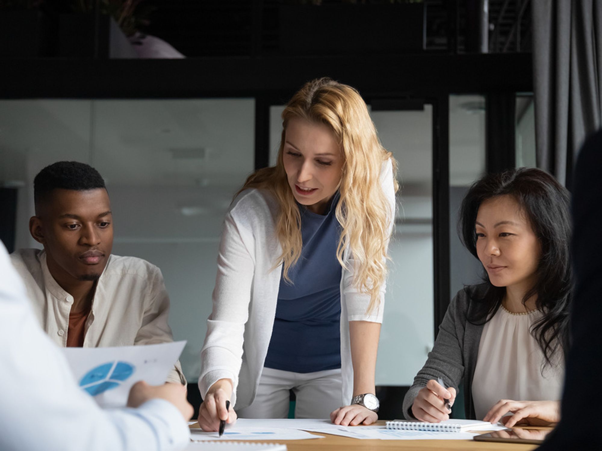 Business leader talks to her co-workers during the COVID-19 pandemic