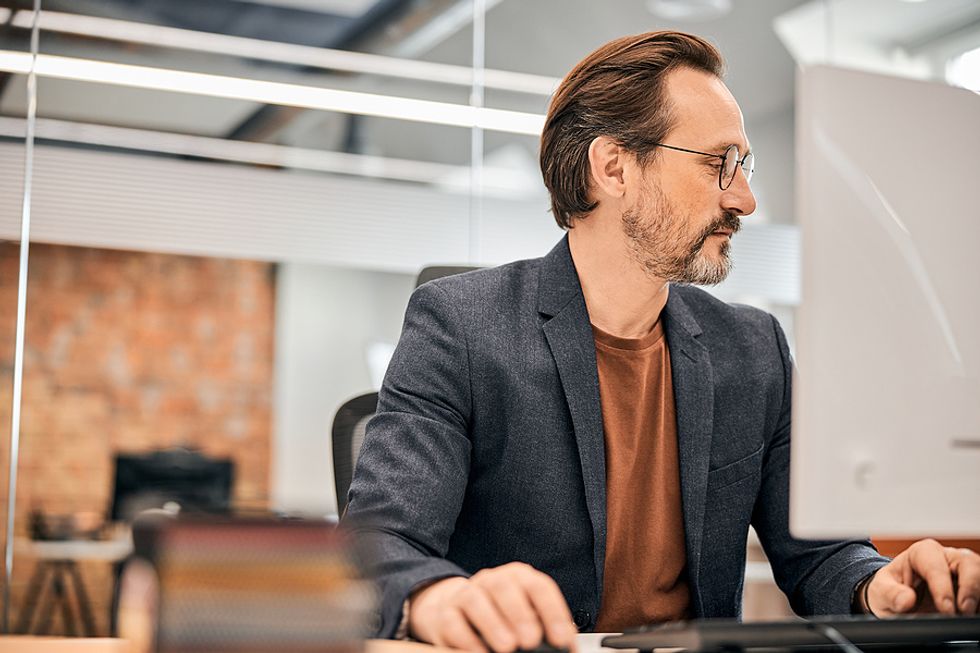 Business man considers a LinkedIn connection request.