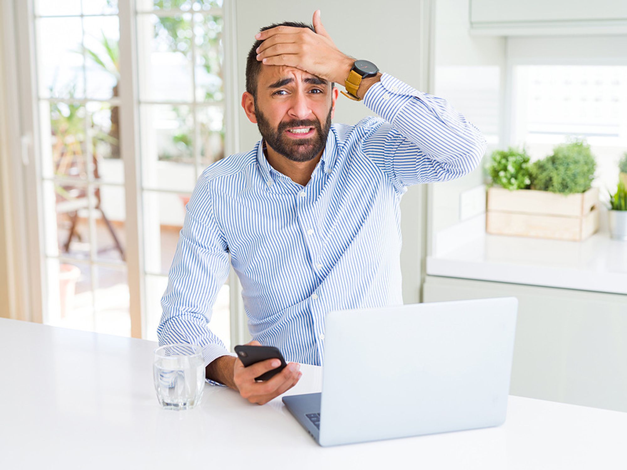 Business man is stressed out after falling victim to a fake job posting scam.