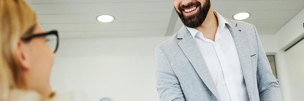 Business man shakes hands with business woman