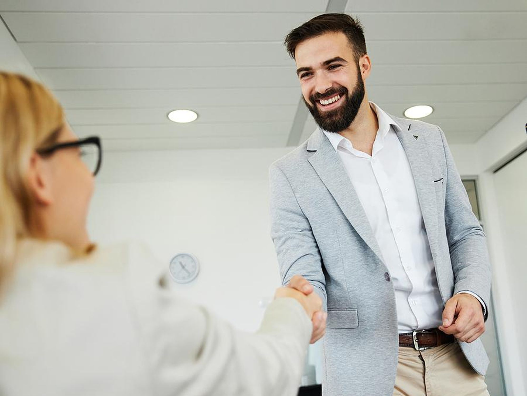 Business man shakes hands with business woman