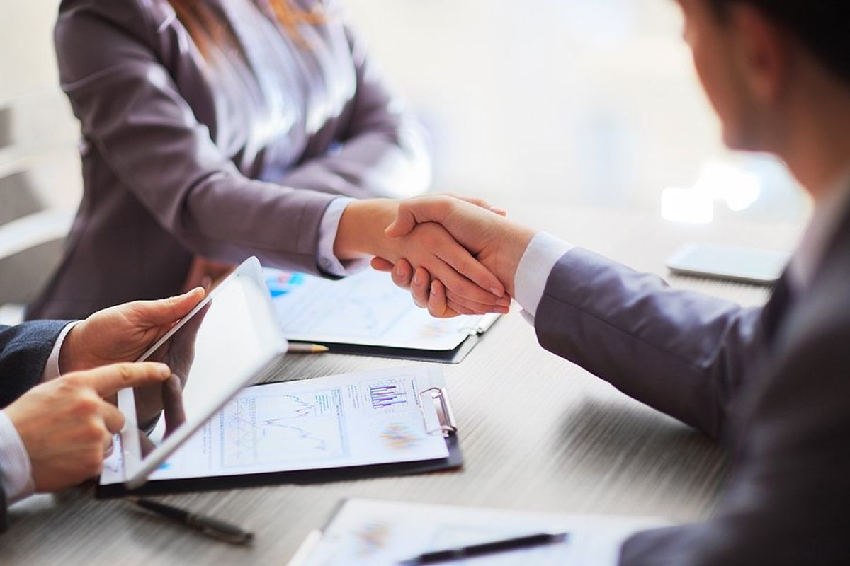 Business people shake hands after making a sale