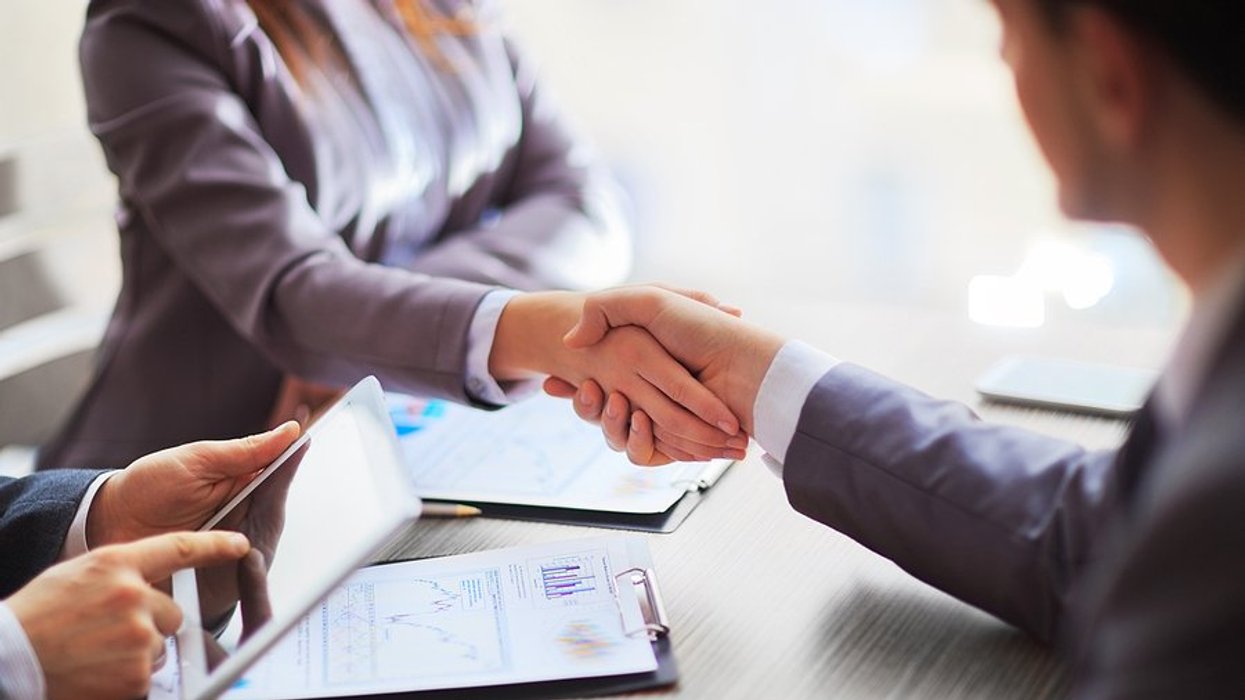 Business people shake hands after making a sale