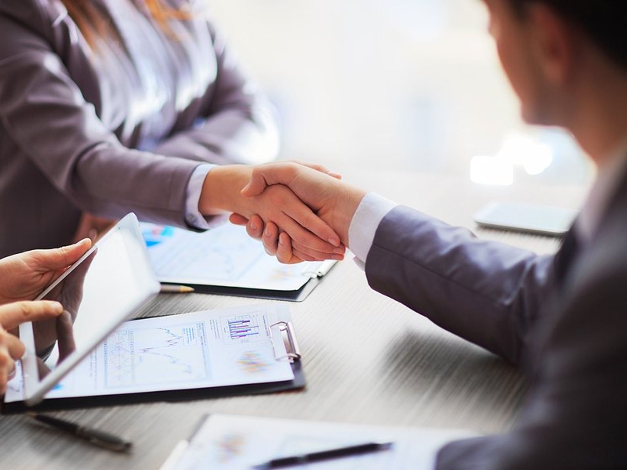 Business people shake hands after making a sale