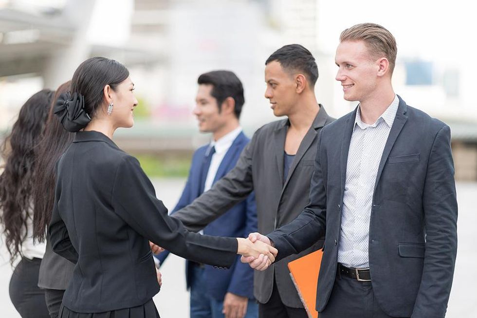 Business professionals meet outside of a LinkedIn event