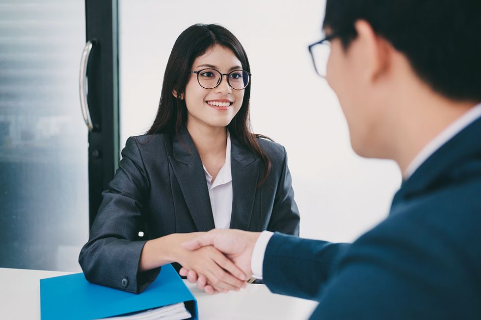 Business woman shaking hands with interviewer